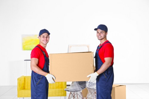 Removalists loading household items into a moving truck