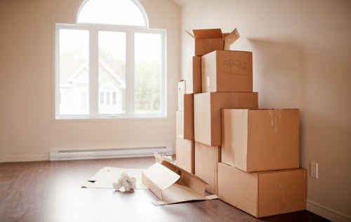Moving company workers organizing packed boxes during a German move
