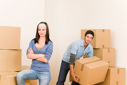 Professional movers carrying furniture through a residential entrance