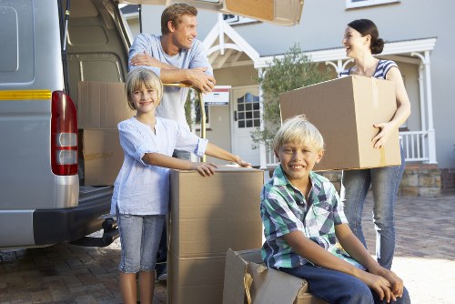 Moving staff wearing PPE while loading items into a vehicle